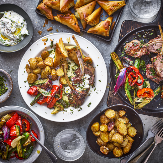 Cypriot-style Lamb Chops, Crispy New Potatoes and Roasted Veg, Tzatziki, and Halloumi and Spinach Filo Parcels