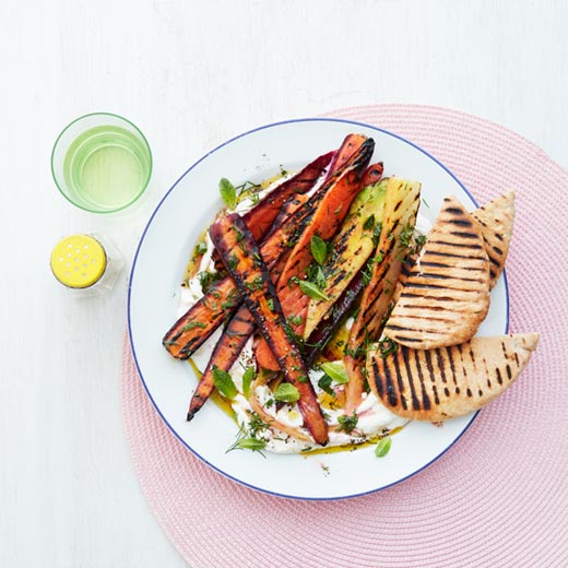 Barbecued carrots with charred pittas and green herb dressing
