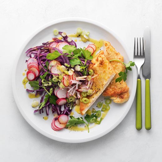Pan-fried chicken breast with red cabbage and radish slaw