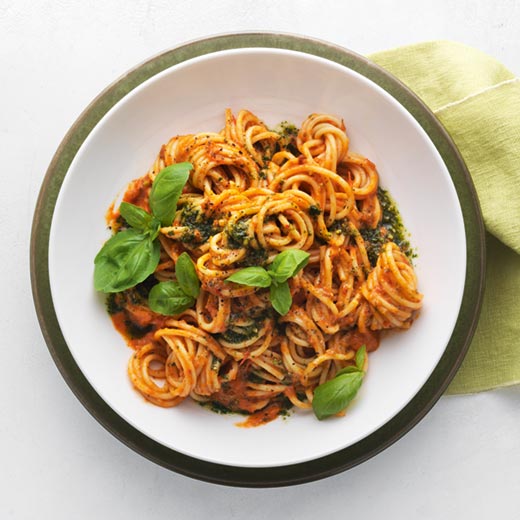 Roasted tomato and red pepper spaghetti with basil and pistachio oil