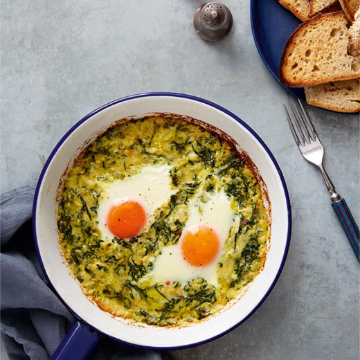 Baked eggs with gruyere, greens and sourdough